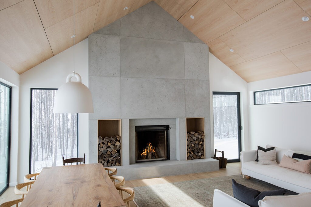 Modern country home with feature concrete fire place burning.