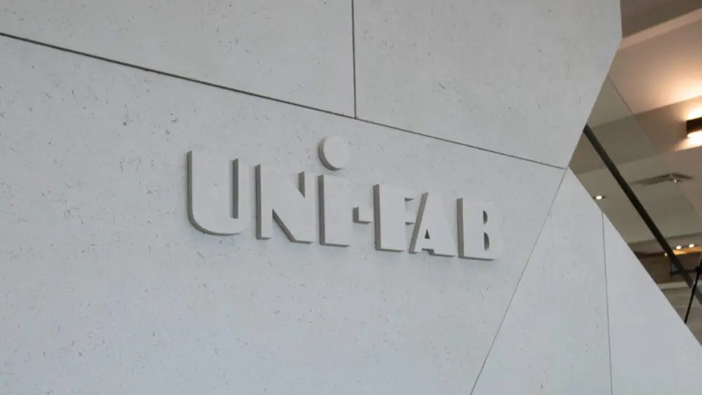 Entrance to office building with 'uni-fab' sign, featuring lightweight concrete cladding, industrial design and concrete feature logo.