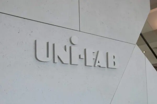 Entrance to office building with 'uni-fab' sign, featuring lightweight concrete cladding, industrial design and concrete feature logo.