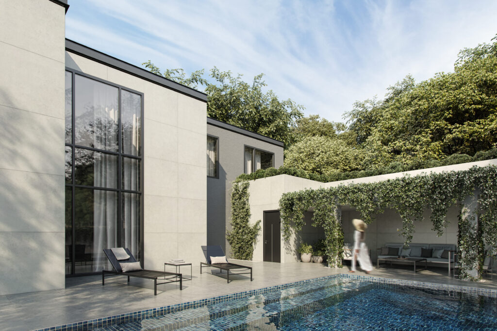 A modern house with exterior concrete cladding featuring a pool and patio. 