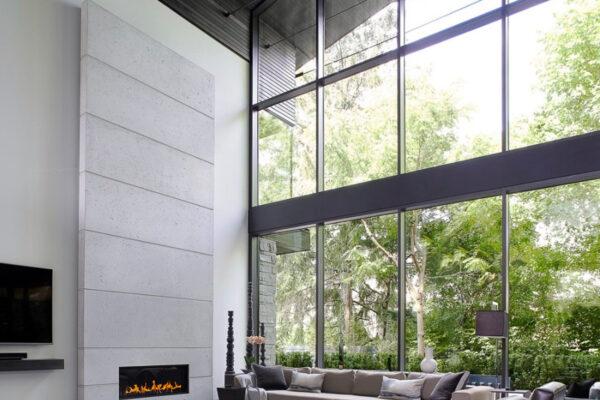 Dekko’s lightweight concrete interior cladding is used in a living room fireplace setting.