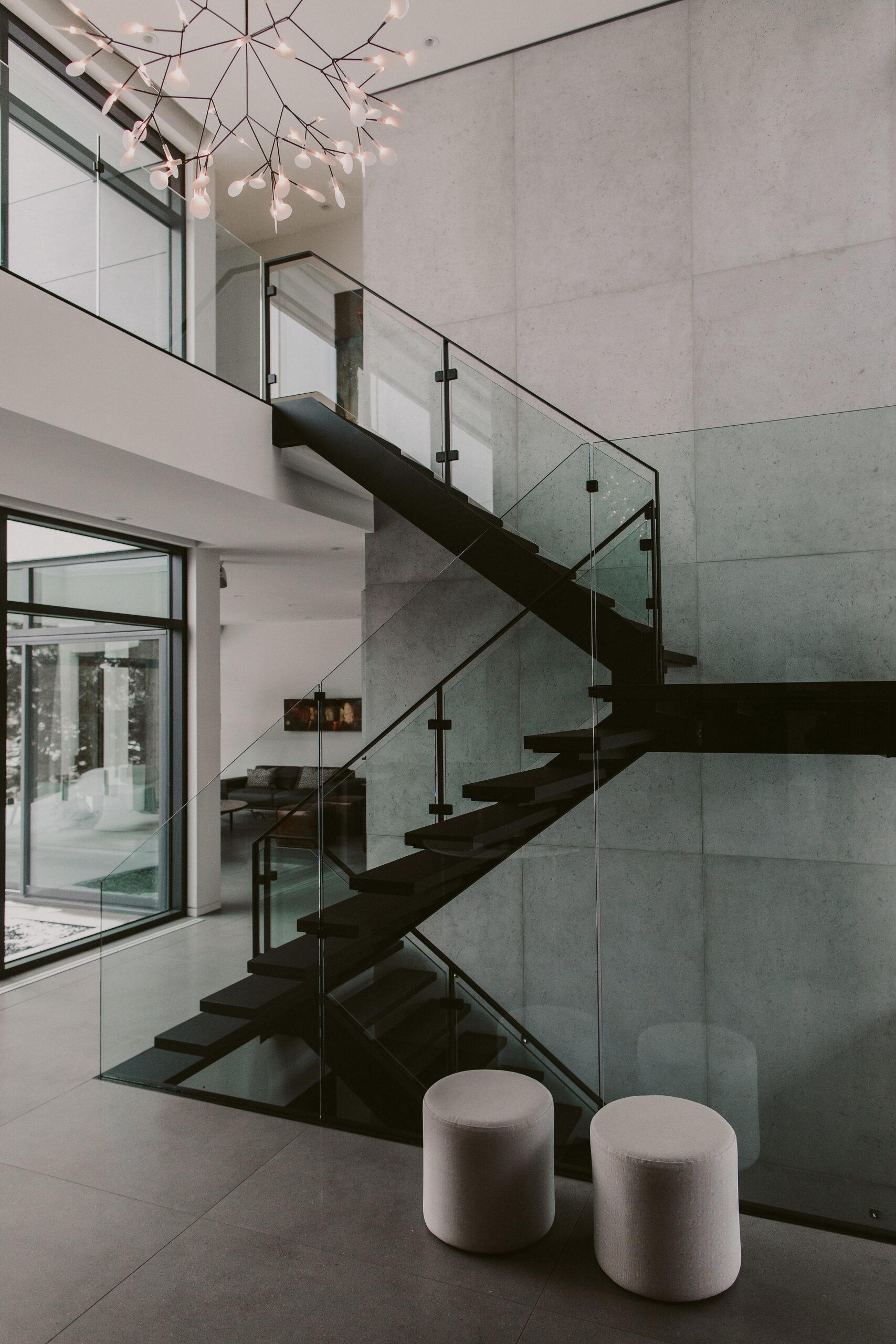 A staircase in a home with its background wall utilizing Dekko’s lightweight concrete cladding.