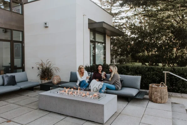 backyard gathering around concrete fire pit.